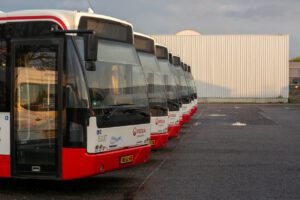 Multiple Veolia buses parked in an urban lot, showcasing public transportation vehicles.
