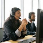 Customer service team working in a modern office with headsets.