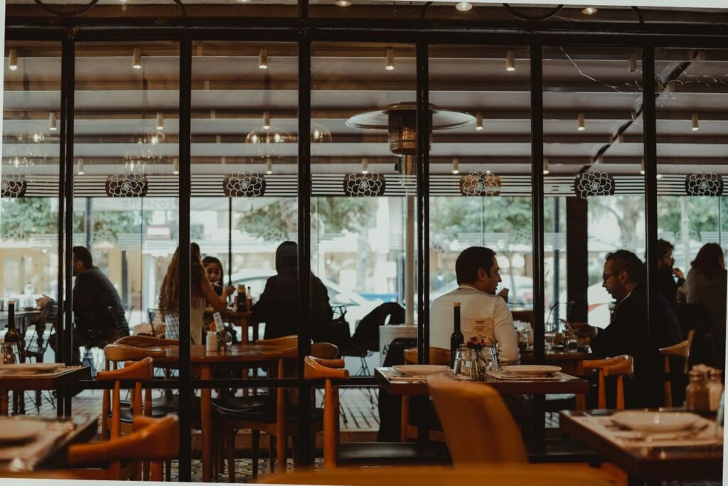 pexels-photo-12181619-12181619 A bustling restaurant interior showcasing diners enjoying their meals in a cozy atmosphere.