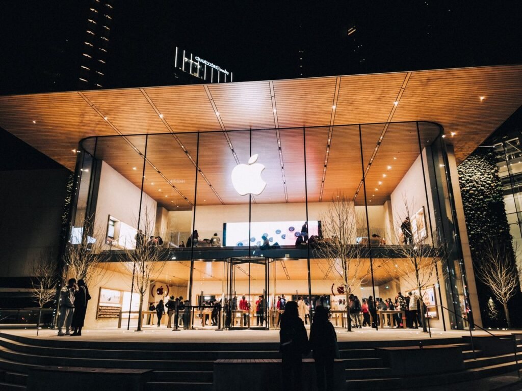 Retail Stores Vibrant night scene of an Apple Store in Vancouver, highlighting modern architecture and urban lifestyle.