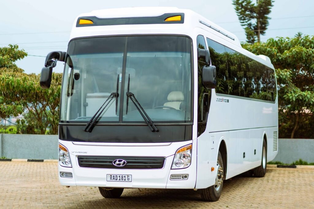 Passenger Fleets Front view of a modern white bus parked in an outdoor setting.