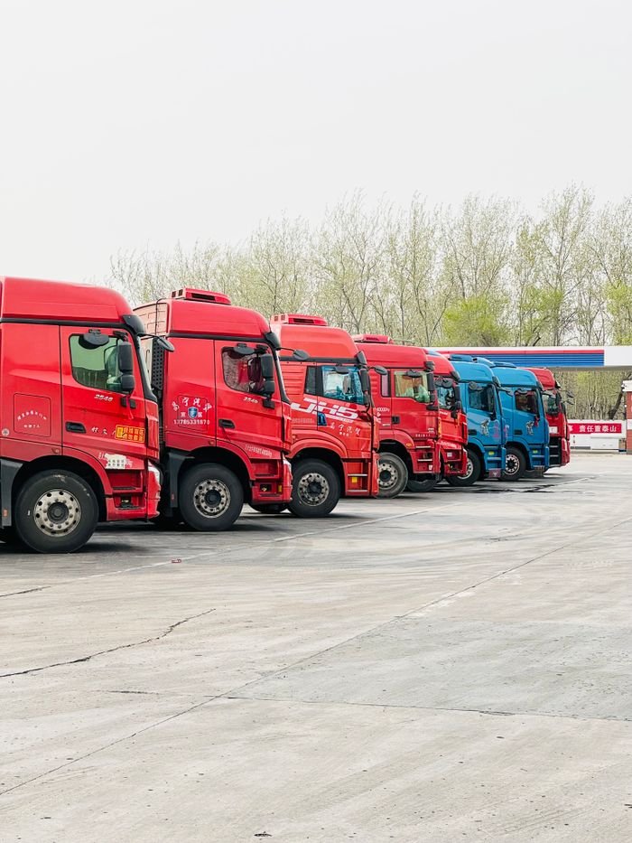 pexels-photo-20882743-20882743 A row of vibrant trucks parked at a transportation depot in Tianjin, China.