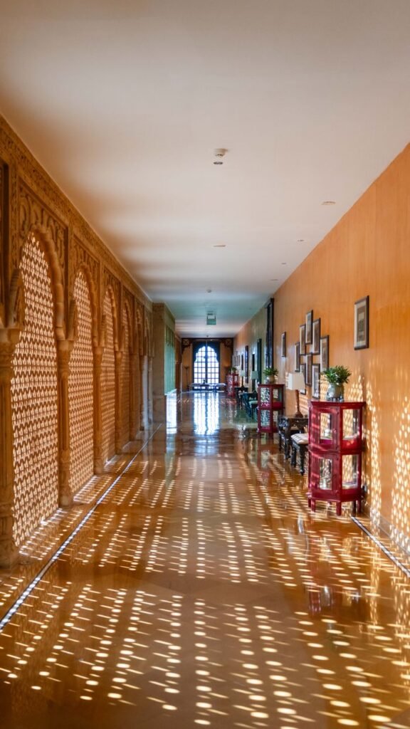 Resort A beautifully lit corridor with carved stone arches at a heritage resort in Jaisalmer, Rajasthan.