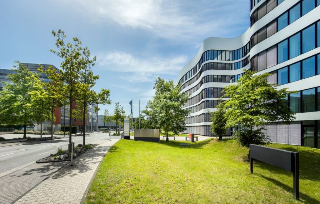 Corporate Campus Contemporary business office building with curved architecture and trees in an urban setting.