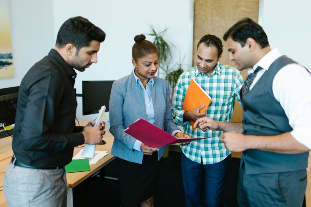 Custom strategy as per your needs Business team engaged in discussion during a meeting in a modern office setting.